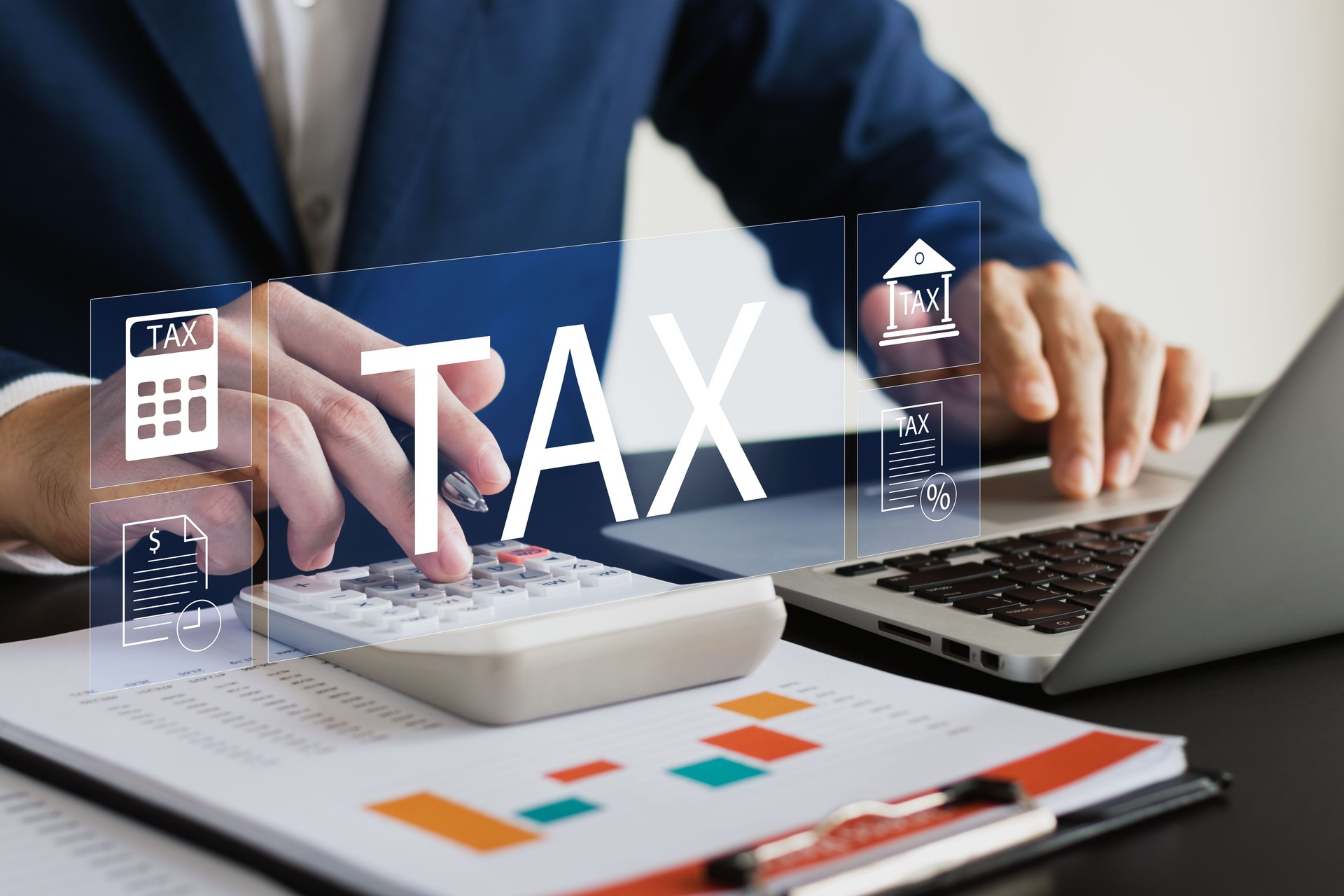 Businessman using his laptop computer to fill out online personal income tax return form for tax payment, personal income tax calculation.